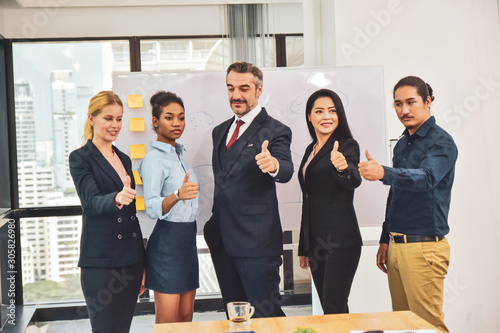 Business team standing in meeting room Thump up Success concept ,Business manager leadership thump up success photo