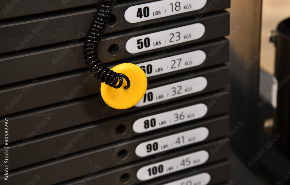 Stacked iron plates on weight machine in gym Stacked iron plates on weight machine in gym