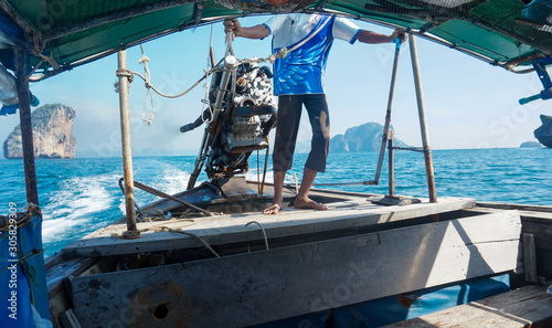 Long tail boat drivers at sea are driving motor surfing in Thailand.