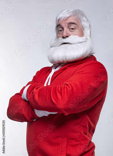 Portrait of a Santa Claus in sportsware with hands crossed photo