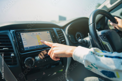 Female's Hand Using GPS Navigation Inside Car. gps Navigation system In car.