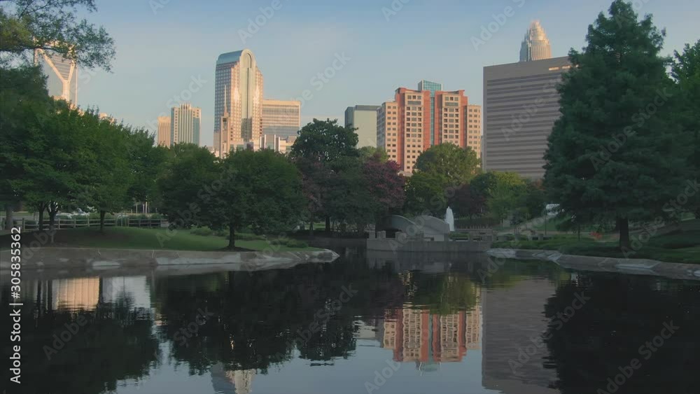 Aerial: flying over pond & fountain in Marshall Park in downtown Charlotte. North Carolina, USA. 10 August 2019 Aerial: flying over pond & fountain in Marshall Park in downtown Charlotte. North Carolina, USA. 10 August 2019