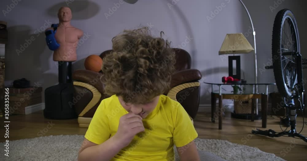 Portrait of addicted Caucasian boy rubbing eyes and yawning as playing at home. Kid with curly hair playing video games all night long. Internet addiction, generation Z. Cinema 4k ProRes HQ. Portrait of addicted Caucasian boy rubbing eyes and yawning as playing at home. Kid with curly hair playing video games all night long. Internet addiction, generation Z. Cinema 4k ProRes HQ.