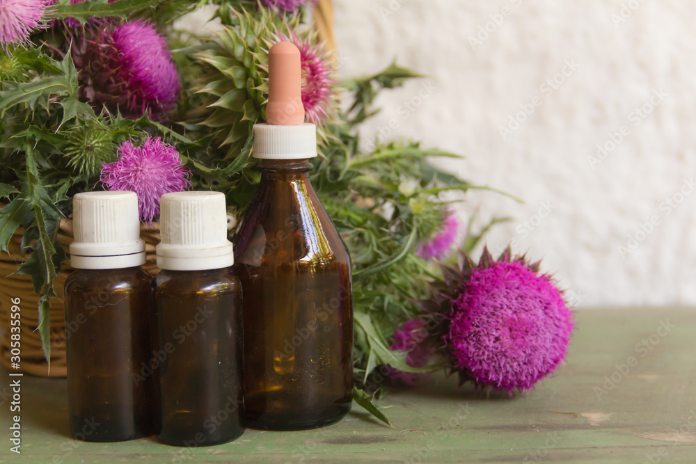 Health concept with essential oils of thistle for alternative medicinal use Health concept with essential oils of thistle for alternative medicinal use