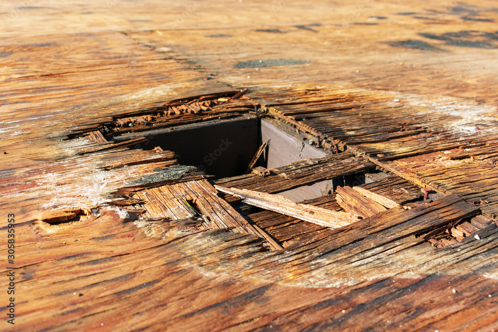 Plywood decking damage and water stains from rain water on flat roof