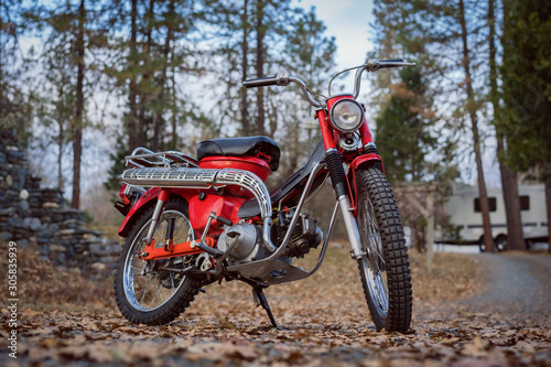 Classic 1969 red motorcycle in the woods in Southern Oregon