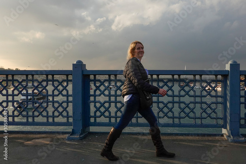 Fototapeta Naklejka Na Ścianę i Meble -  Istanbul, Turkey Women pedestrians on the Galata Bridge