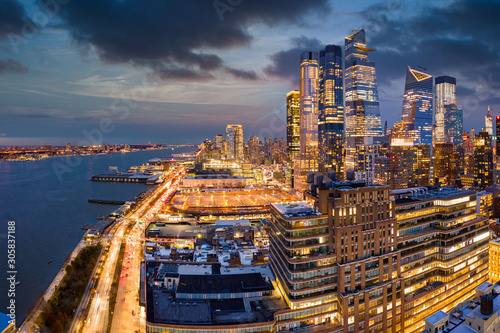 Aerial panorama of New York City skyscrapers at dusk as seen from above the 12th avenue and 26th street, close to Hudson Yards and Chelsea neighborhood