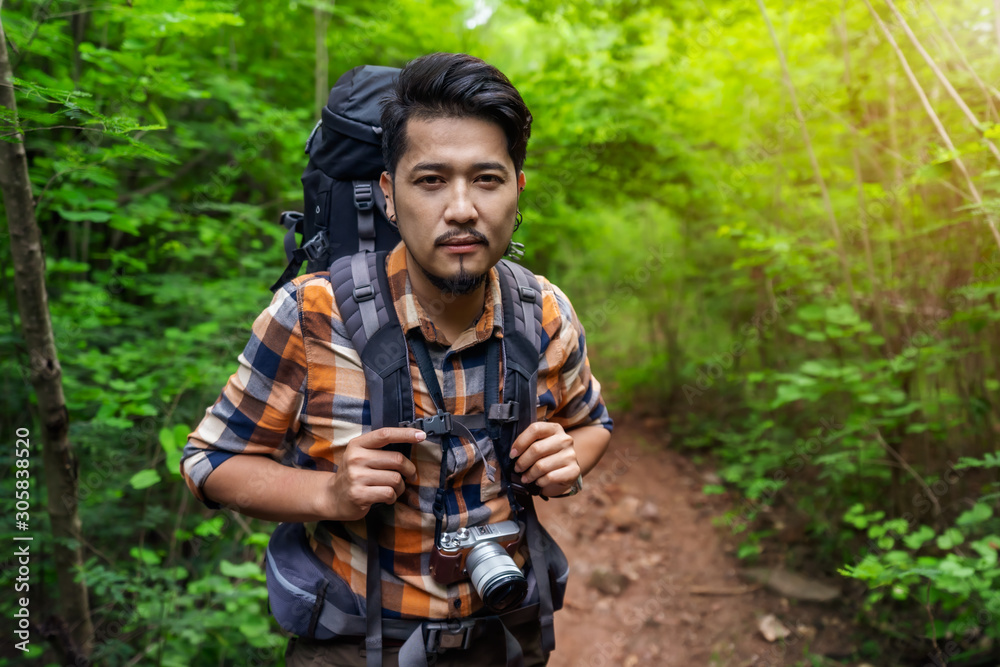 man traveler with backpack in the forest man traveler with backpack in the forest