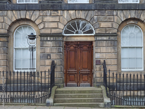 Photography Old European stone building with carved wooden door