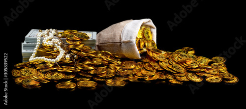 Stack bundles of 100 US dollars banknotes and gold coin on black background