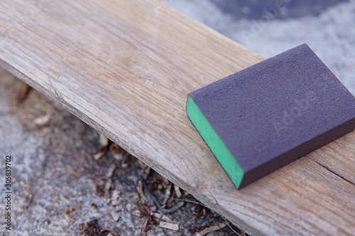 Sandpaper for polishing wood Laying on a wooden plate.