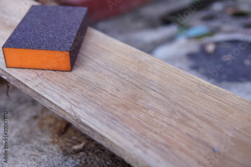 Sandpaper for polishing wood Laying on a wooden plate.