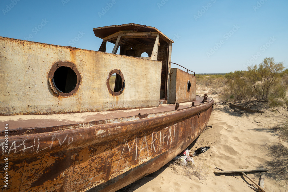 Rusty ship wreck in the deserted Aral Sea near Muynak en Uzbekistan Rusty ship wreck in the deserted Aral Sea near Muynak en Uzbekistan