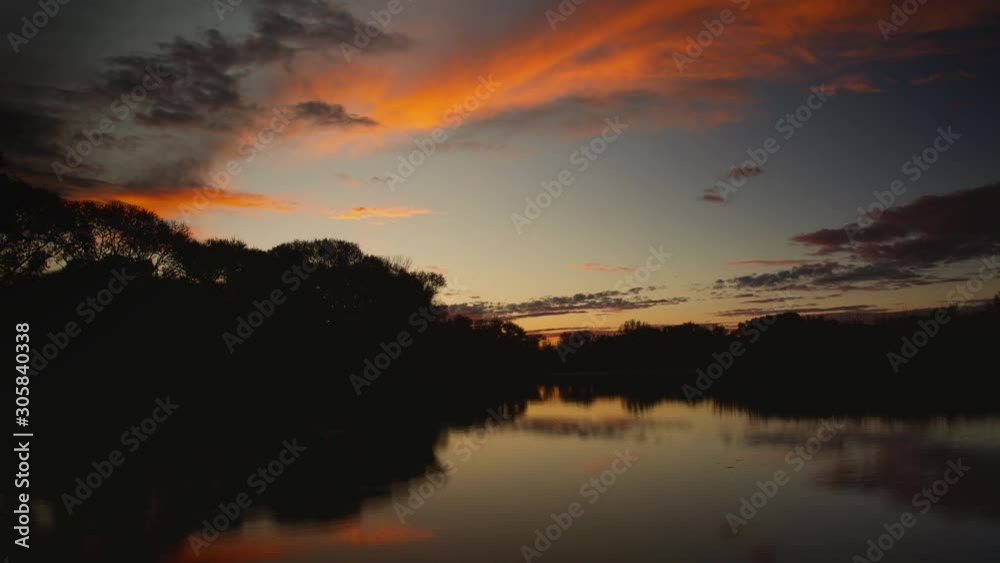 Pink Clouds Reflected in Lake at Sunrise time Lapse Pink Clouds Reflected in Lake at Sunrise time Lapse