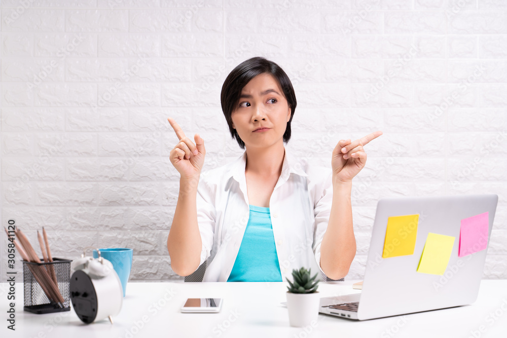 Portrait of a confused woman sitting at office Portrait of a confused woman sitting at office