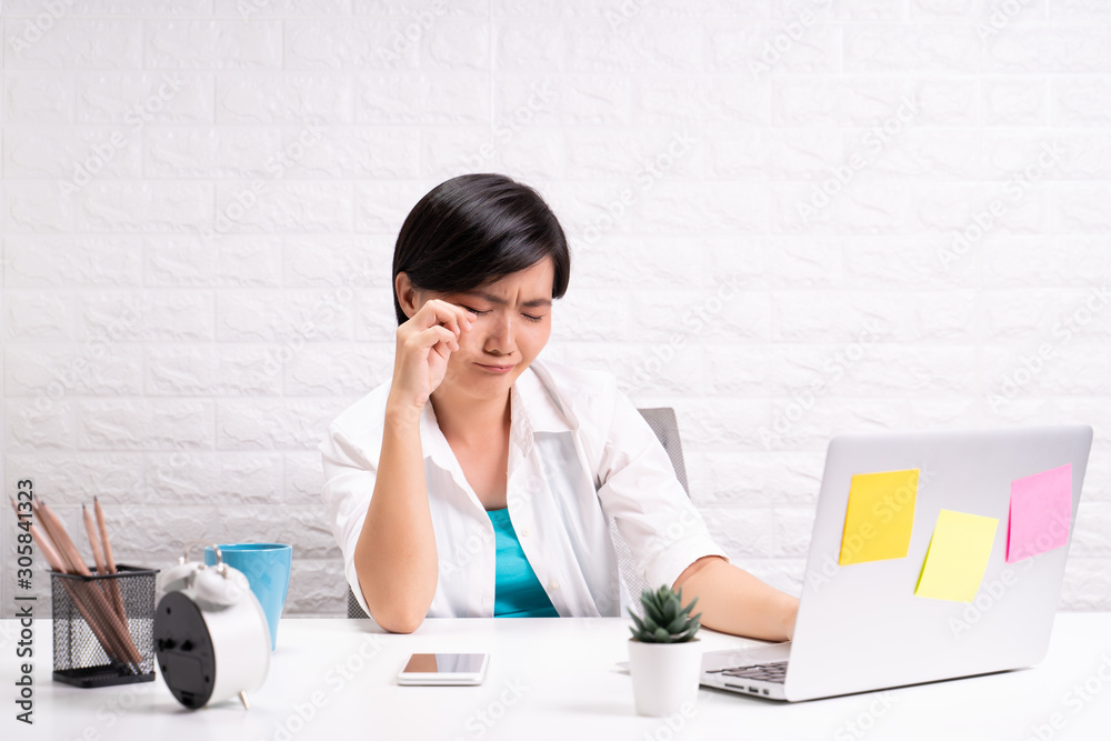 Sad woman sitting at home office working using computer laptop Sad woman sitting at home office working using computer laptop