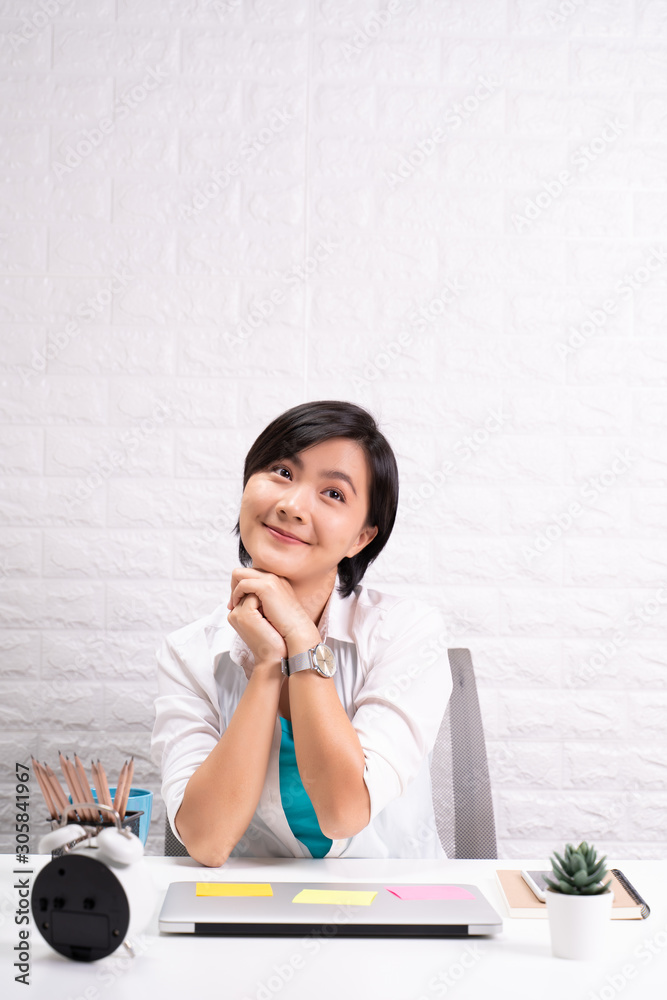 Portrait of a confidence woman sitting at office Portrait of a confidence woman sitting at office