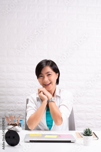 Portrait of a confidence woman sitting at office