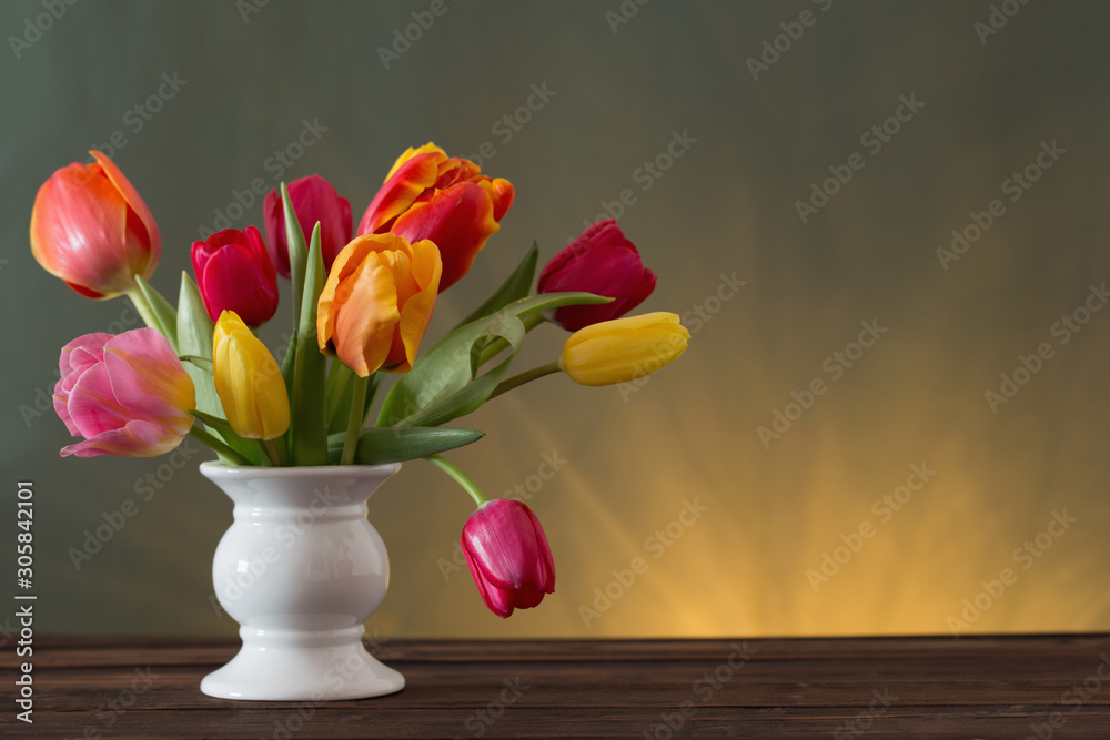 beautiful tulips in vase on green background beautiful tulips in vase on green background