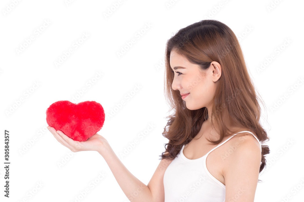 Portrait of beautiful asian young woman holding red heart shape pillow and smile isolated on white background, valentines day, holiday concept. Portrait of beautiful asian young woman holding red heart shape pillow and smile isolated on white background, valentines day, holiday concept.