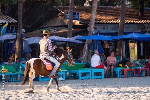 Prachuab Khirikhan, Thailand - November, 16, 2019 : Unidentified name people riding a horse in sunset time at Huahin beach of Prachuap Khiri Khan,Thailand