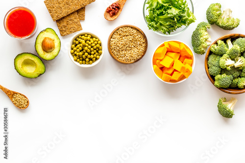 Healthy food. Vegatables and fruits on white background top view frame copy space photo