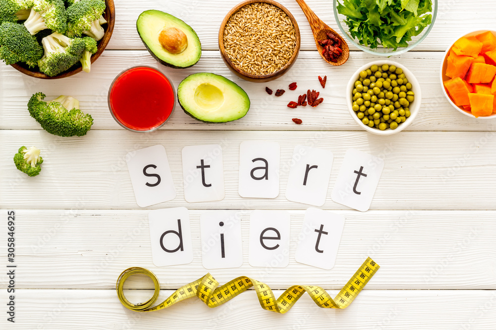 Start diet text near healthy food on white wooden background top view - obrazy, fototapety, plakaty 