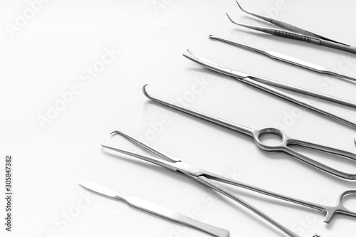 Instruments for plastic surgery on white background flat lay pattern copy space