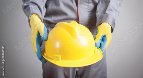 Worker with a yellow helmet.