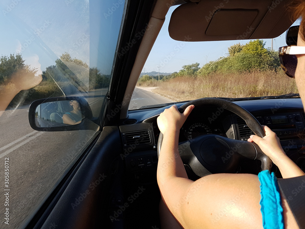 Fototapeta premium driving steering wheel road wooman's hands