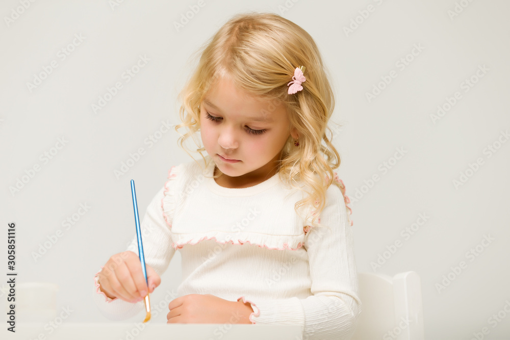 Little girl draws paints.montessori education. Little girl draws paints.montessori education.