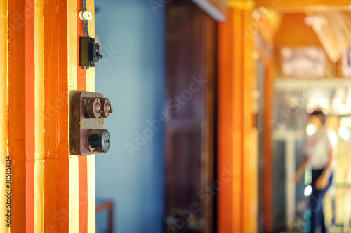 Close up to a very old light electric retro switch on on a wooden board. Vintage switch, Selective focus