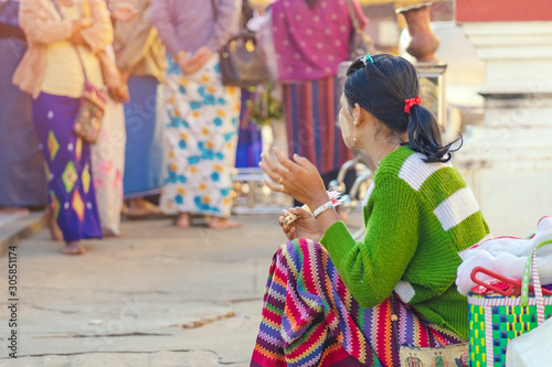 Female tourists make merit and photographing at Shwezigon Pagoda in Bagan, Myanmar.