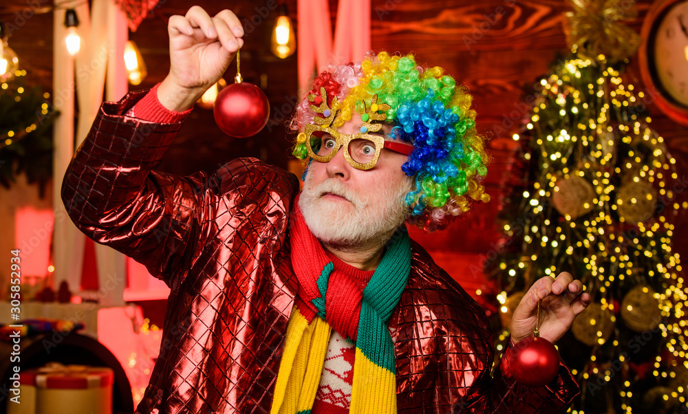 Hocus pocus. Christmas spirit. Cheerful clown colorful hairstyle. Bearded senior man celebrate christmas. Party entertainment. Mature man with white beard. Winter holidays. Christmas decorations home