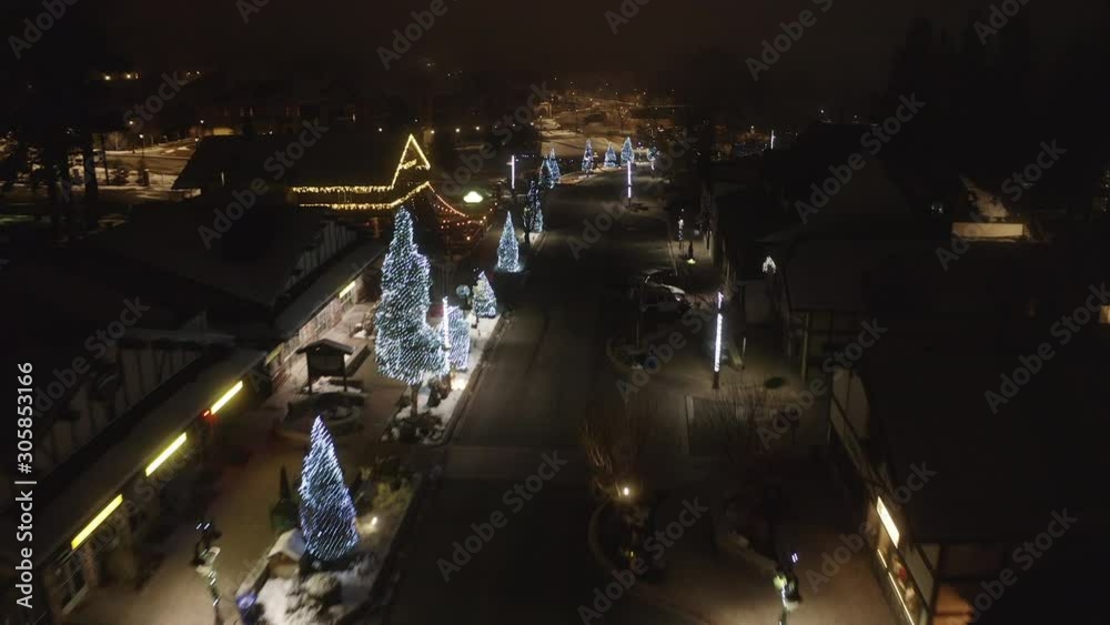  Flying over a Snow covered town with Christmas Lights   