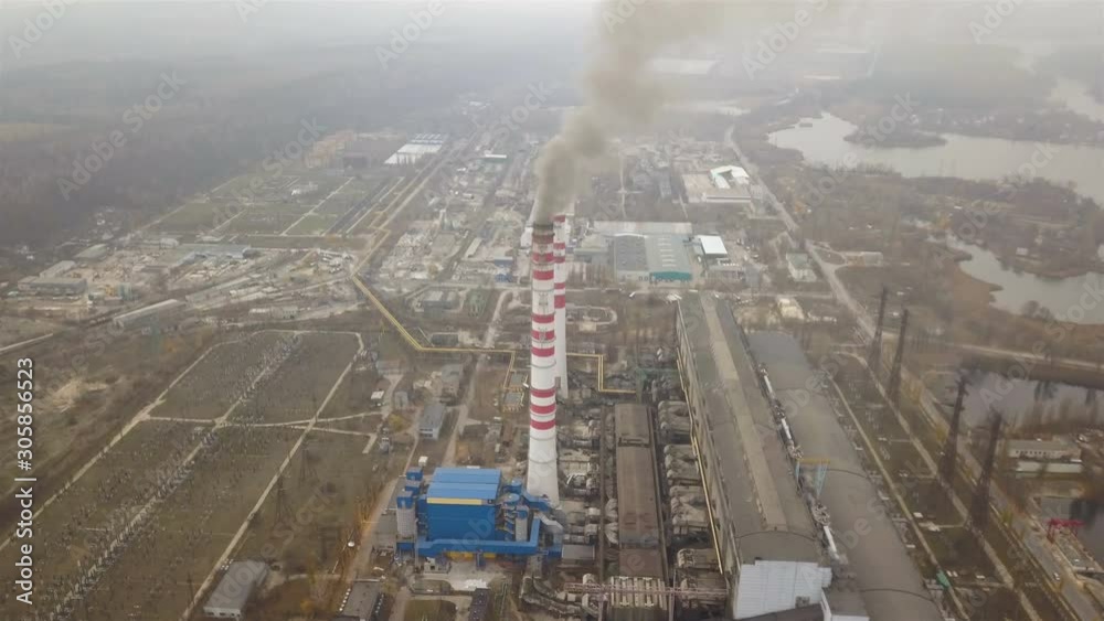 4K .Aerial. Industrial area with pipes and smoke in gloomy day. Old
