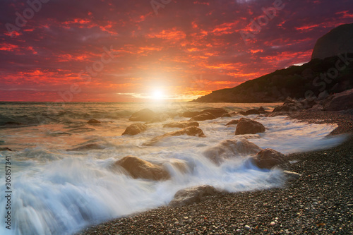 Dramatic sunset over the stormy sea. Summer vacation on tropical resort.