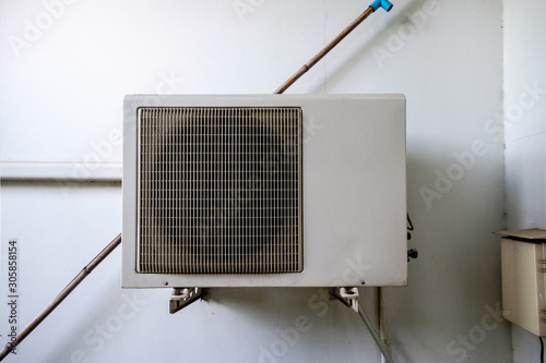 Air conditioning system assembled on the white wall with area for logo and brands photo