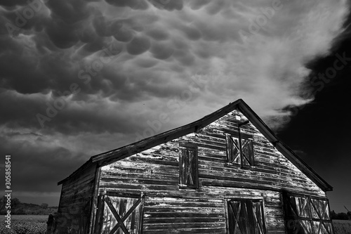 Thick mammatus storm clouds above a beautiful wooden country barn near Healdsburg, Sonoma County, California. photo