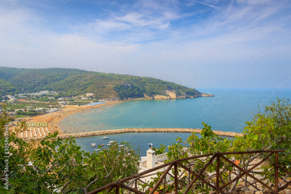 Panoramic view of the bay of Peschici: the marina and the sandy beach, Italy (Puglia). Peschici is famous for its seaside resorts, its territory belongs to the Gargano National Park.