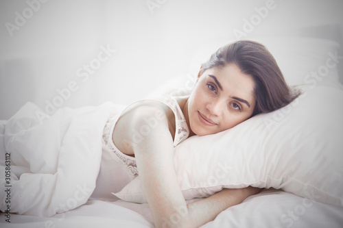 beautiful young woman basking in bed in the morning. Beautiful