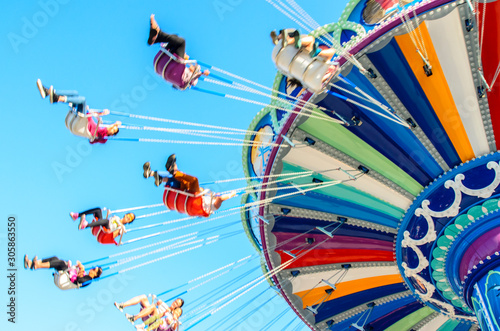 Fototapeta Naklejka Na Ścianę i Meble -  Blurred imaged of colorful summer carnival ride