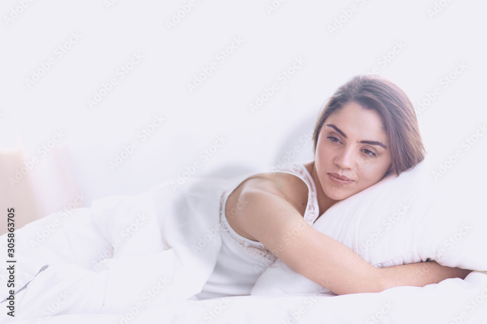 beautiful young woman basking in bed in the morning. Beautiful beautiful young woman basking in bed in the morning. Beautiful