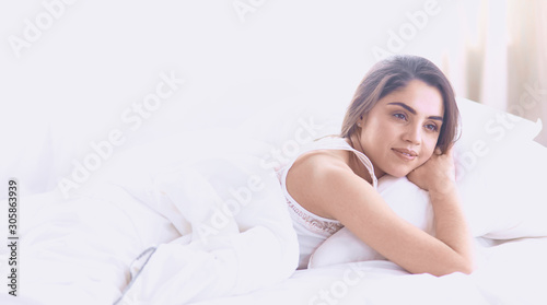 beautiful young woman basking in bed in the morning. Beautiful