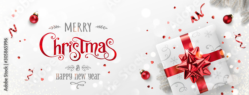 Red Christmas and New Year Text on Xmas background with gift boxes, fir branches, red ribbon, decoration, sparkles, confetti, bokeh. Merry Christmas card. Vector Illustration, realistic vector