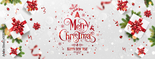 Red Christmas and New Year Text on Xmas background with gift boxes, fir branches, red ribbon, decoration, sparkles, confetti, bokeh. Merry Christmas card. Vector Illustration, realistic vector