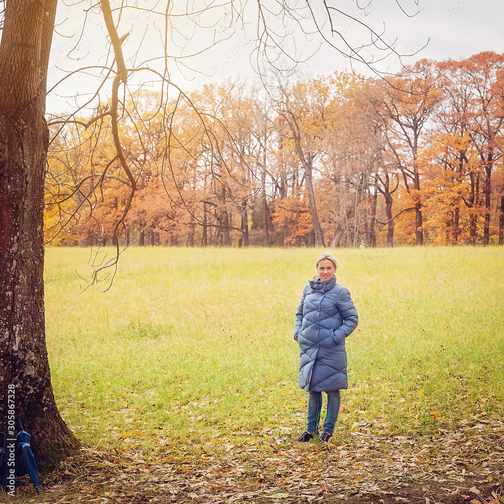 A woman walks in the autumn Park A woman walks in the autumn Park