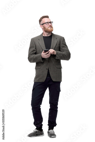 confident man looking at the screen of his smartphone . isolated on white © ASDF