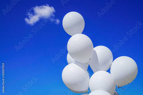 white balloons on a background of blue sky. 